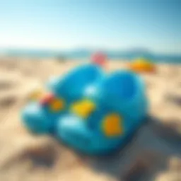 Colorful baby beach shoes on sand
